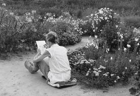 Artist, elderly Woman drawing flowers outdoor