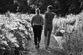 man and woman on a walk in black and white background