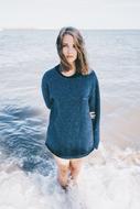 beautiful girl in a long sweater in the water