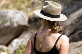 photo of a girl in a straw hat on a background of mountains