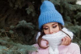 young Woman in winter clothe at fir tree, Portrait