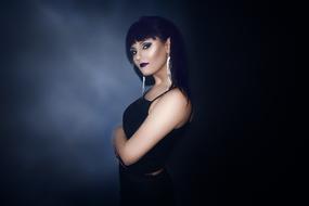 Girl in black posing in studio