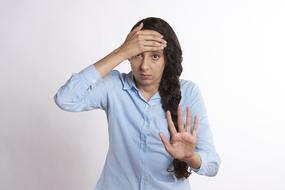 Shocked girl with hand at forehead