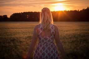 woman on the field at sunset