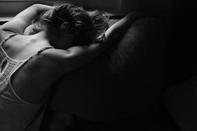 Woman laying on bed face down