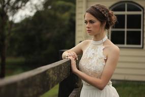 portrait of serious Bride at wooden fence