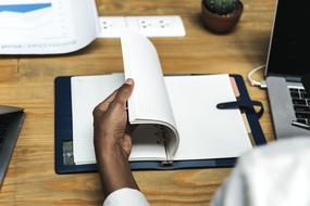 Blank pages of notebook in male hand