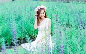 cute woman on the meadow with wreath