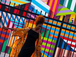 african american young girl posing at colorful wall