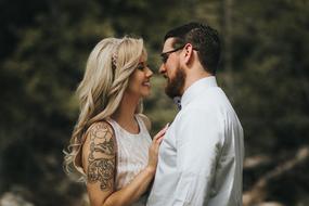 girl with a tattoo and a young man with a beard