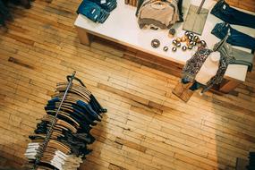 Colorful clothes, hanging and on the table, in the store