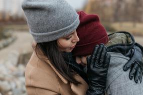 mom and daughter outdoors on a cloudy day