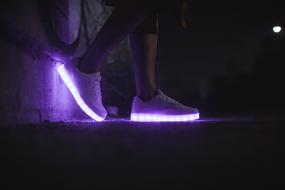 personâs legs in light-on Shoes at darkness