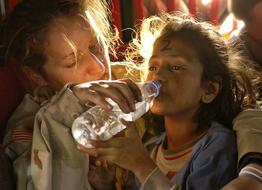Humanitarian Aid, child girl Drinks Water
