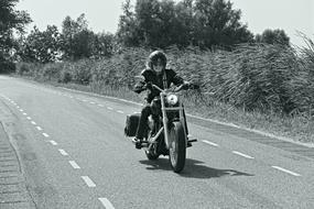 female Biker speeding on road