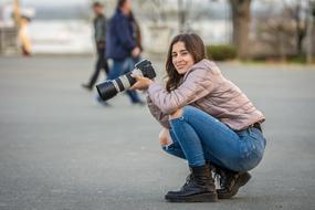 photographer, happy young girl in winter clothing