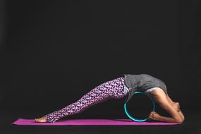 girl is doing fitness on a pink mat