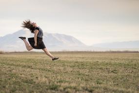photo of a jumping girl on the field