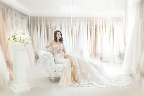 girl in a wedding dress sitting on the couch