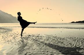woman playing with water on the beach
