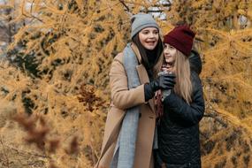 daughter with mother in autumnal park