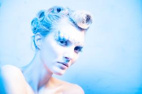 Lovely Girl with bright makeup in blue light