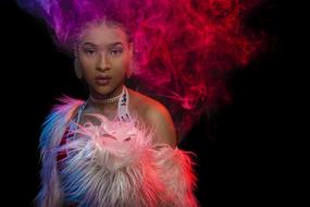 singer with colorful feathers posing