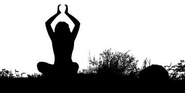 black silhouette of a girl doing yoga on the field