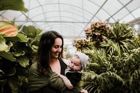 woman with baby in botanical garden