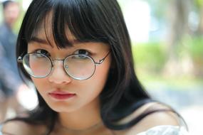 photo of asian student wearing round glasses