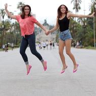 mother and daughter jumping in the park