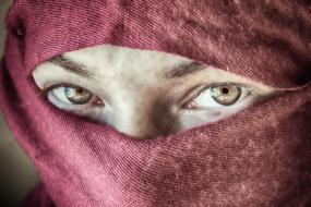 woman with face covered in red cloth