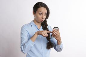 surprised girl with a smartphone in her hands