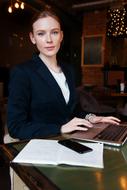 Business Lady, young Woman at table with gadgets