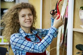 cheerful young woman at work in Shop