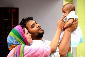happy Family with baby on hands