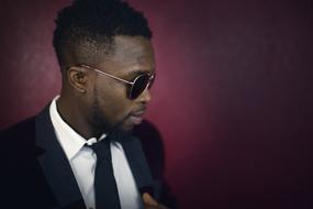 young Afro American man in Black tie suit and glasses