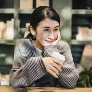 Asian woman drinking coffee