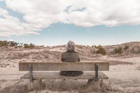 Person Old Woman on bank on sand dunes