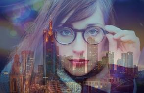 reflection of a girl with skyscrapers in the window