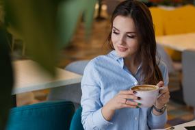 girl with a cup of coffee in a restaurant