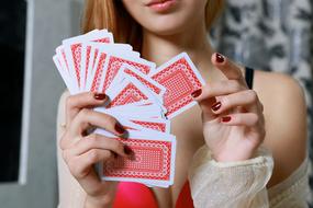 young sexy Woman holds playing cards