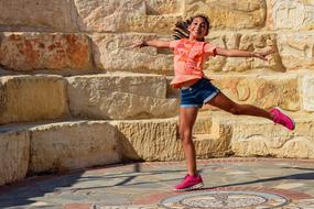 photo of a dancing girl in an antique amphitheater