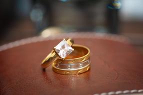 photo of two wedding rings on a leather sofa