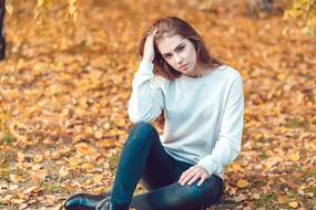 photo of a young Russian girl on a background of autumn foliage