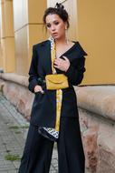 Fashion model in Designer clothing at wall
