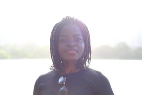 photo of a beautiful black girl in a sunny day