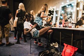 preparing Girls in dressing room with makeup mirrors