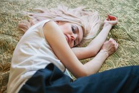 blonde with long hair on the bed