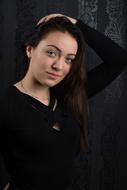 long hair Girl in Black with hand on head